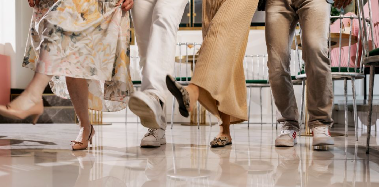 A cropped image of members from the knees down, showing fancy line-dancing footwork on the dance floor.